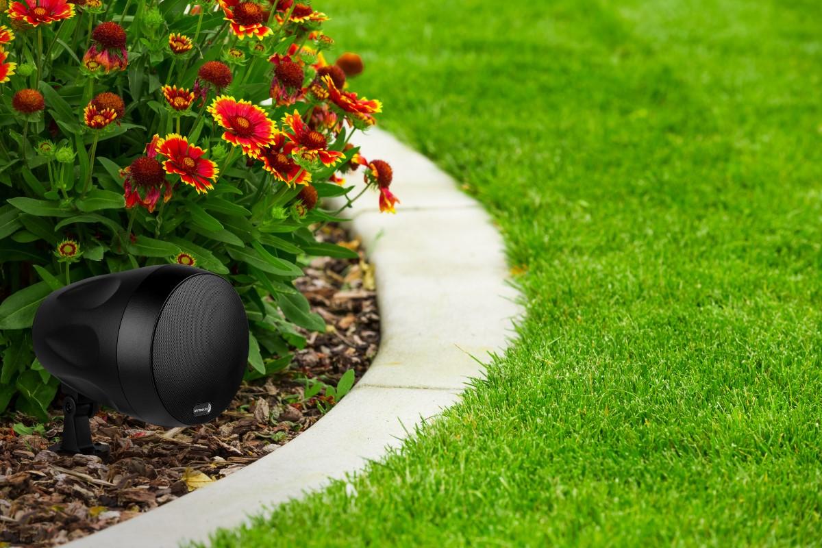 Dayton Audio Landscape Pendant Speaker positioned among plants in a garden.